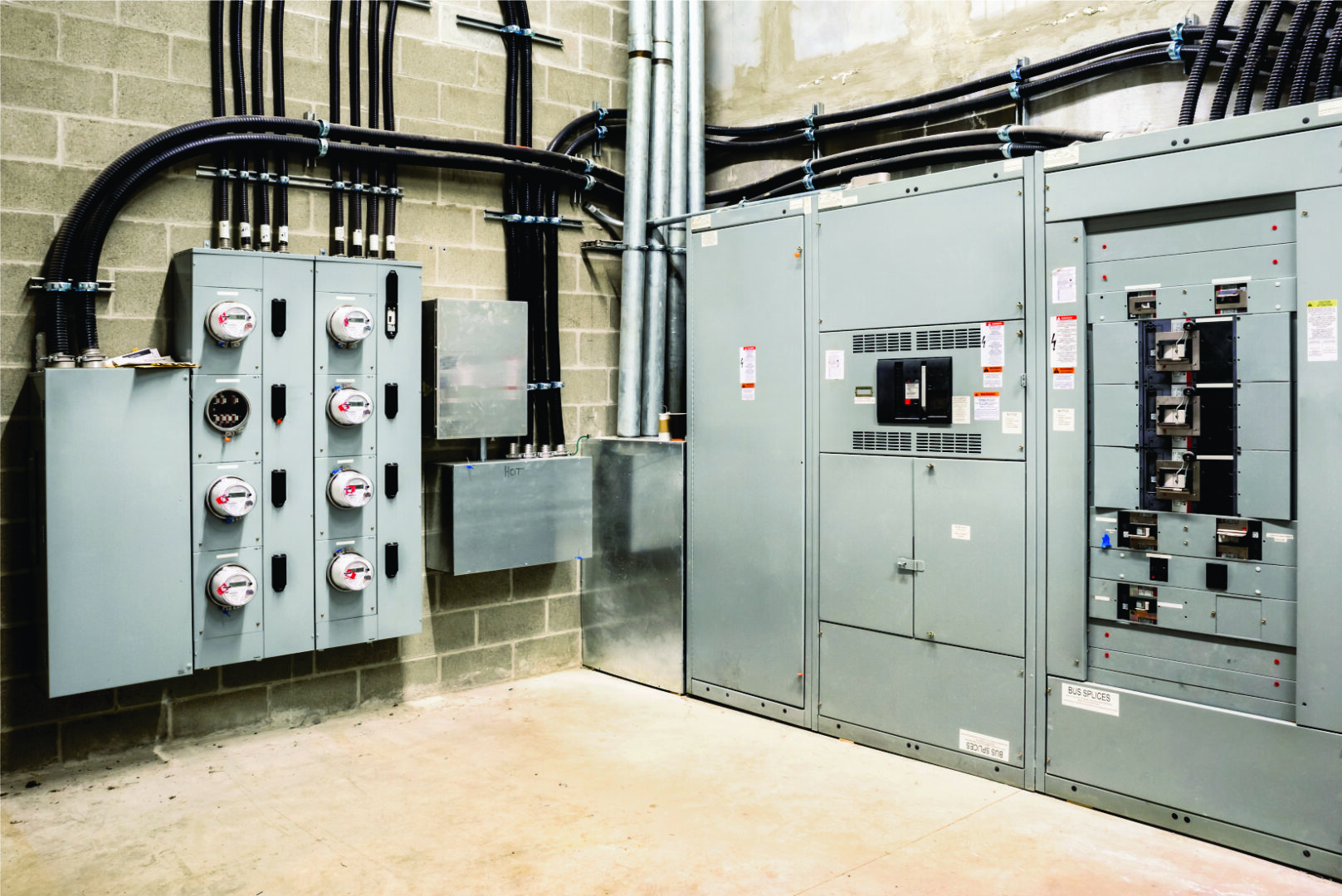 A room with many electrical boxes and wires.